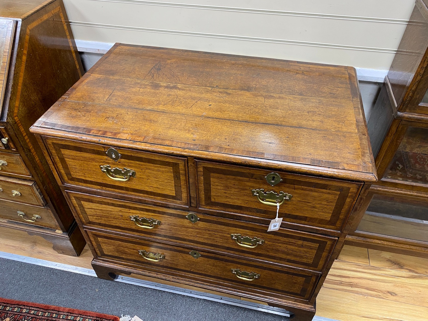 An 18th century mahogany banded oak four drawer chest, width 95cm, depth 57cm, height 88cm